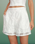 Pantalones cortos blancos de jacquard con bolsillos elegantes