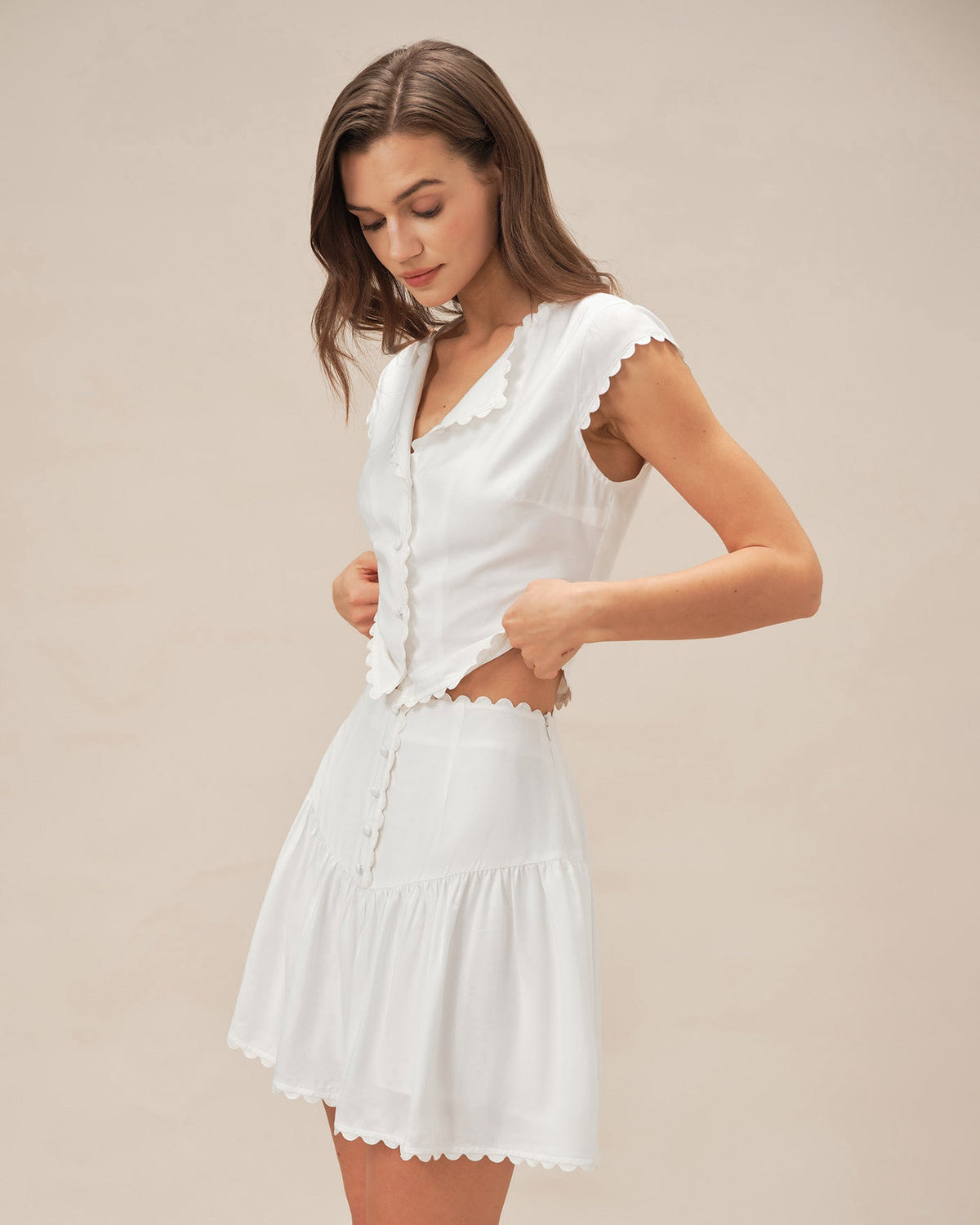 Falda mini blanca elegante fruncida con botones delanteros